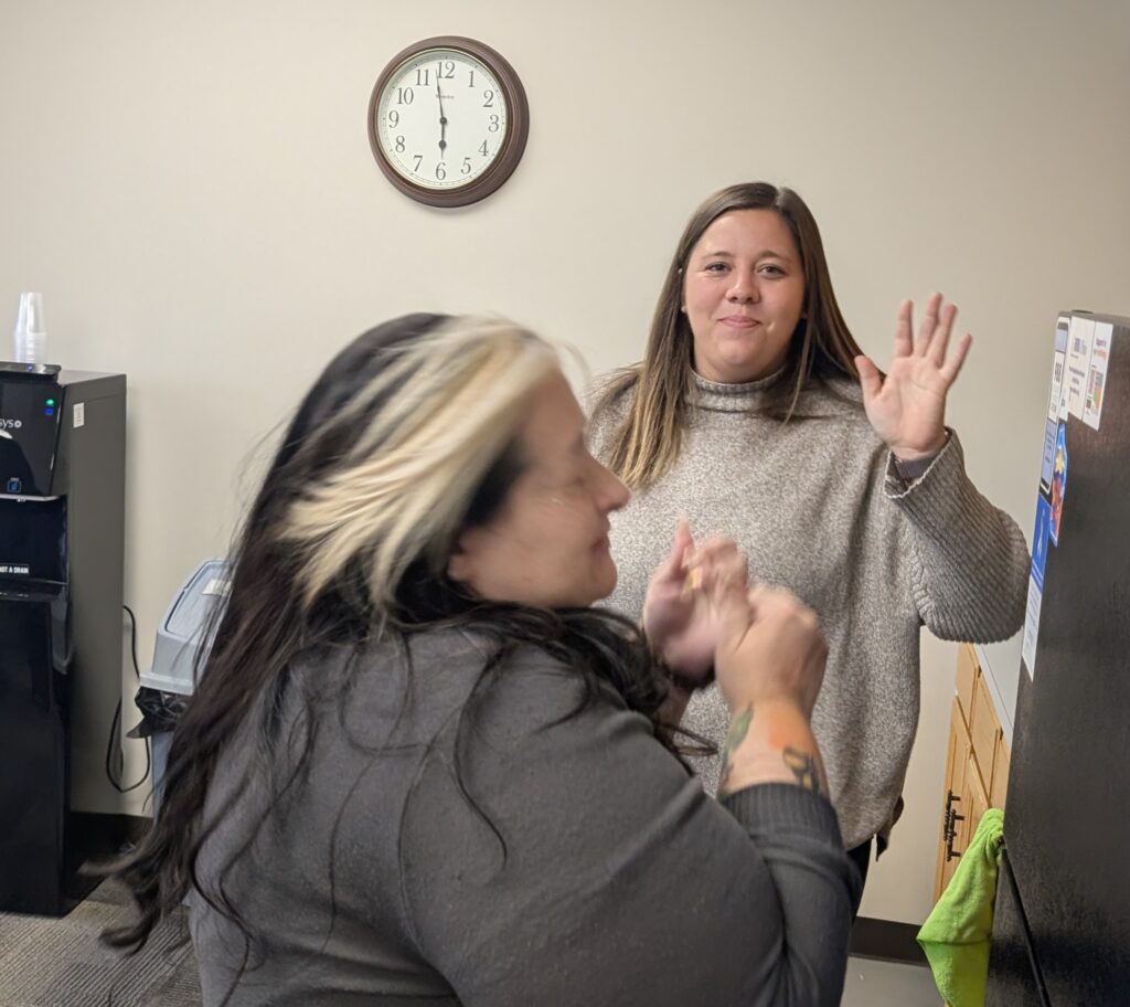 LOSS Team member waving and another laughing
