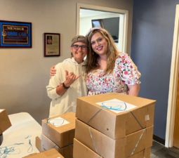 2 LOSS Team members smiling about all the cookies being boxed.