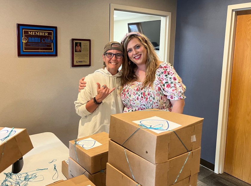 2 LOSS Team members smiling about all the cookies being boxed.