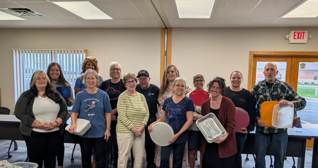 Group picture of LOSS Team members holding empty cookie containers