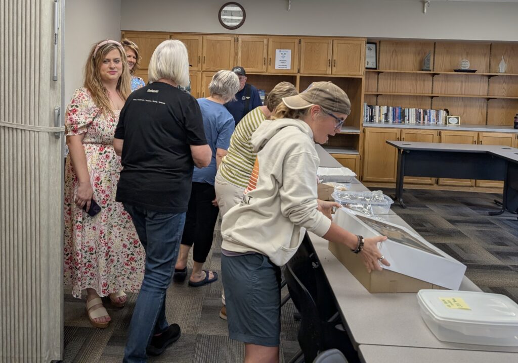 Members of the Four County LOSS Team packing up cookies.