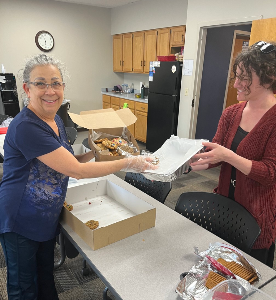 2 LOSS Team members opening cookies to divide