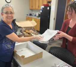 2 LOSS Team members opening cookies to divide